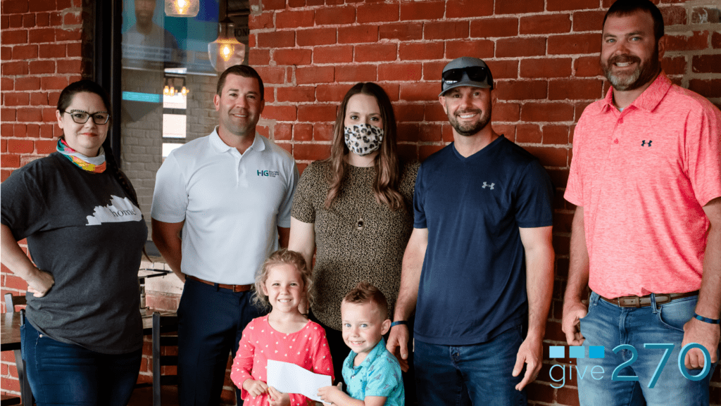 Robin Monroe, manager of Impellizzeri’s, Justin Howard, an insurance agent at Curneal Hignite Insurance, Jarrod Butler, owner of Heartland Cleaning Services (and his children Evelyn and Maximus), and Roman Ritchey owner of Ritchey Landscaping and Lawncare, present a check to Karen Ward (center) for fundraiser proceeds totaling nearly $38,000.